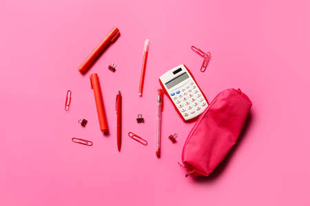 Pencil case with stationery and calculator on color backgroundの写真素材