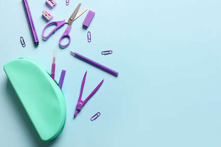 Composition with pencil case and stationery on blue background