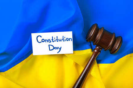 Judge gavel and card with text CONSTITUTION DAY on flag of Ukraineの写真素材
