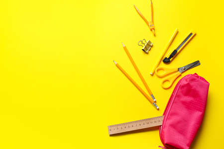 Stylish pencil case and stationery on yellow backgroundの写真素材