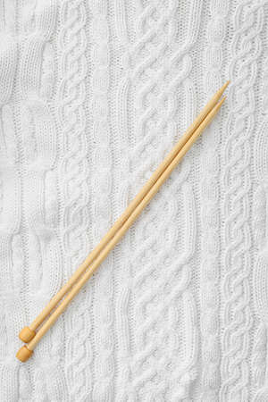 Knitted clothes and needles, closeupの写真素材