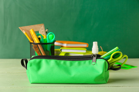 Pencil case with stationery on wooden tableの写真素材