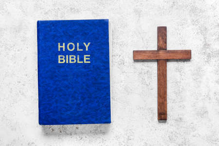 Holy Bible with wooden cross on white backgroundの写真素材