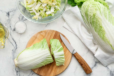 Board with fresh cut chinese cabbage on light backgroundの写真素材