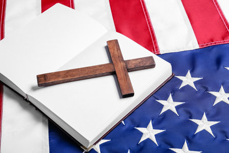 Open book with cross on USA flagの写真素材