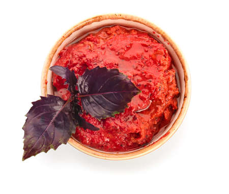 Bowl of tasty pesto sauce on white backgroundの写真素材