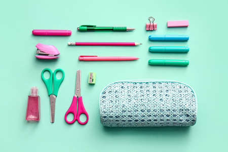 Composition with pencil case, stationery and sanitizer on color backgroundの写真素材