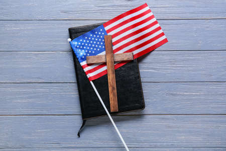 Holy Bible with cross and USA flag on blue wooden backgroundの写真素材