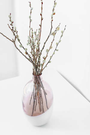 Vase with willow branches on tableの写真素材