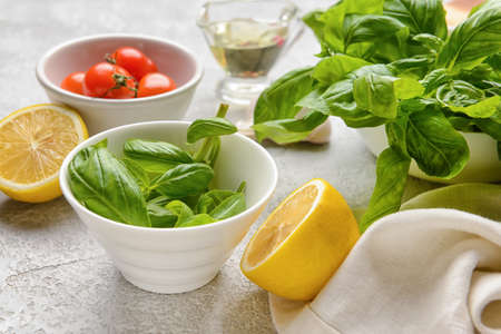 fresh basil leaves and different products on light backgroundの写真素材