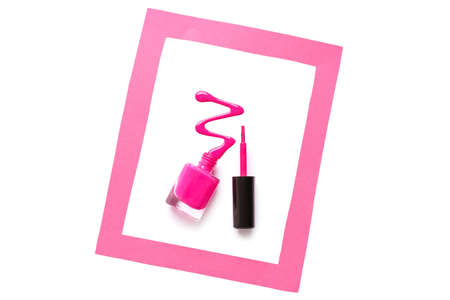 Bottle of nail polish with brush and blot in frame on white backgroundの写真素材