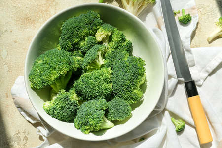 Bowl with healthy broccoli cabbage on light backgroundの写真素材
