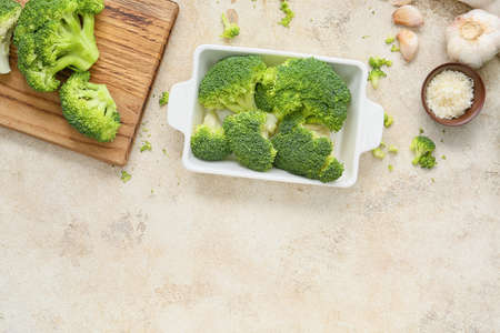 Baking dish with healthy broccoli cabbage on light backgroundの写真素材