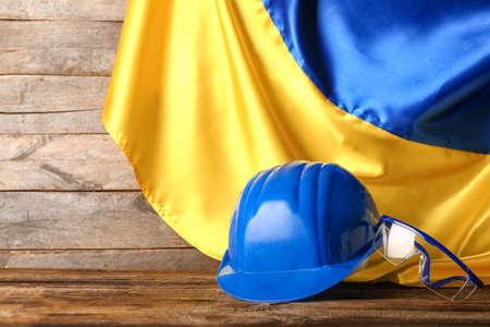 Builder's equipment and flag of Ukraine on wooden backgroundの写真素材