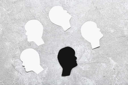 Paper human heads on light background. concept of racismの写真素材