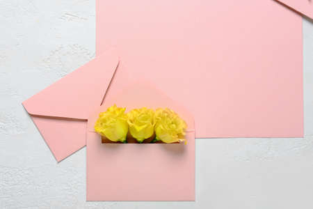 Blank card and envelopes with roses on white backgroundの写真素材