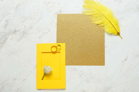 Blank cards with wedding rings, rose and feather on white background