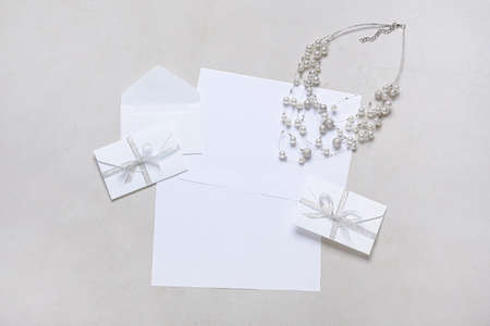 Envelopes with blank cards and necklace on white backgroundの写真素材