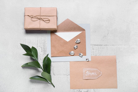 Envelope with card, box and diamonds on white background