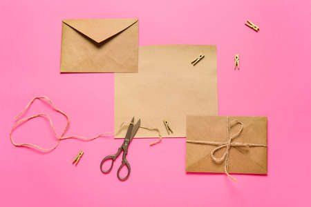 Blank card with envelopes and rope on pink background