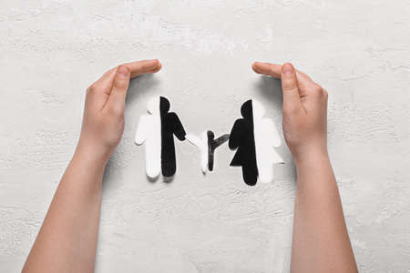 Woman and paper family figure on light background. concept of racism