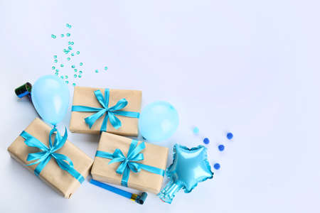 Gift boxes and balloons on light backgroundの写真素材