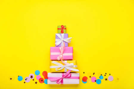 Gift boxes and confetti on color background