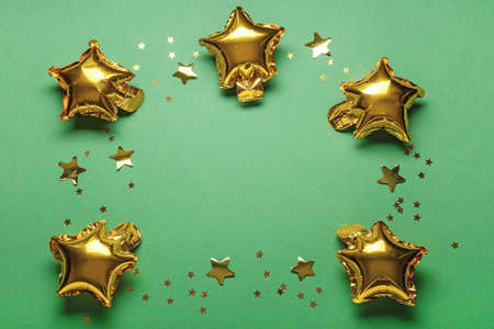 Frame made of air balloons and confetti on color background