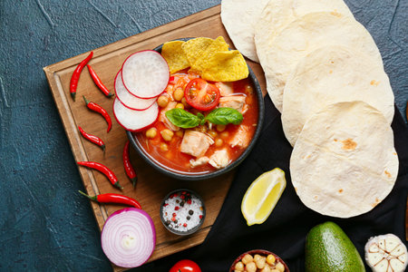 Composition with tasty pozole soup and ingredients on dark backgroundの写真素材