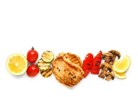 Tasty grilled vegetables and steaks on white backgroundの写真素材