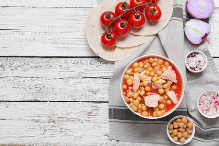 Bowl with delicious homemade pozole soup and ingredients on light wooden backgroundの写真素材