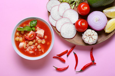 Composition with delicious homemade pozole soup and ingredients on pink backgroundの写真素材