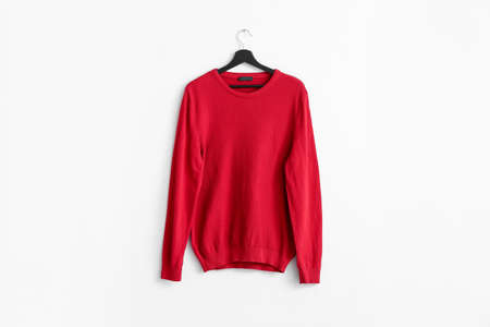 Hanger with stylish sweater on white backgroundの写真素材