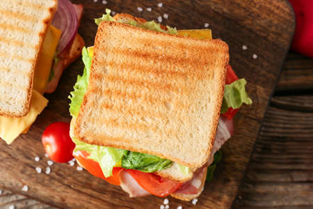 Board with tasty sandwiches on wooden background, closeupの写真素材