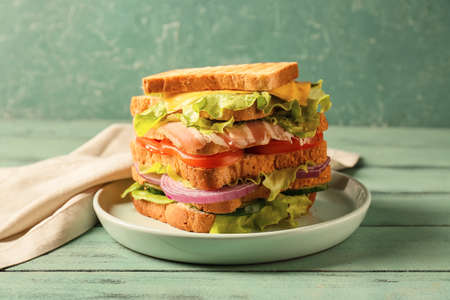 Plate with tasty sandwich on table, closeup