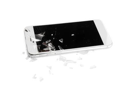 Mobile phone with broken screen and pieces of glass on white background