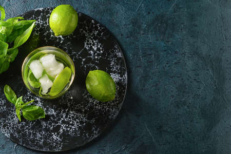 Glass of lemonade with basil on dark backgroundの写真素材