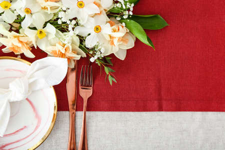 Beautiful table setting with narcissus flowers