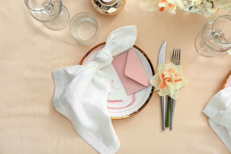 Beautiful table setting with narcissus flowersの写真素材