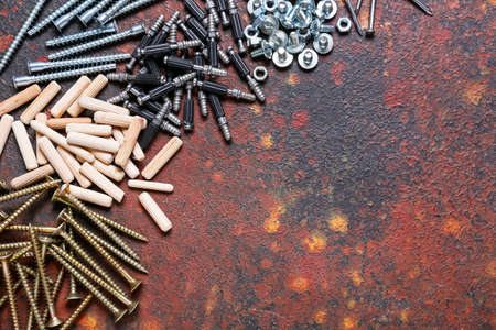 Set of different nuts, bolts, screws, nails and dowels on color backgroundの写真素材
