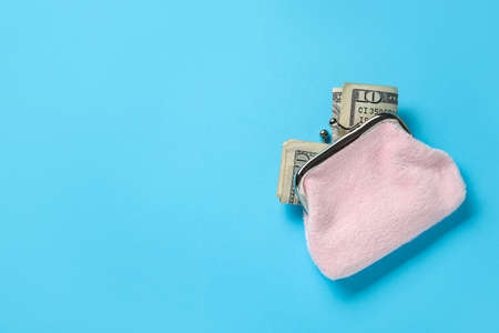 Pink wallet with banknotes on blue backgroundの写真素材