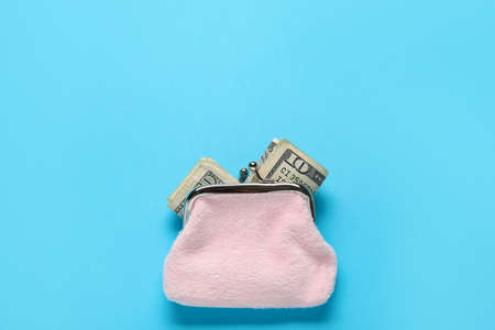 Pink wallet with banknotes on blue backgroundの写真素材