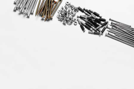 Piles of bolts screws and nails on white background, closeupの写真素材
