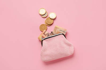 Small wallet with money on pink backgroundの写真素材
