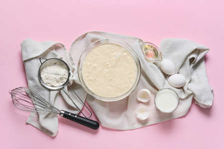 Raw batter with whisk and ingredients on color backgroundの写真素材