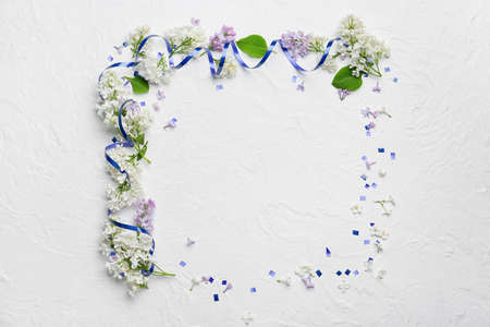 Frame made of beautiful lilac flowers on light backgroundの写真素材