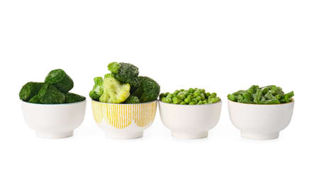 Bowls with frozen green vegetables on white backgroundの写真素材