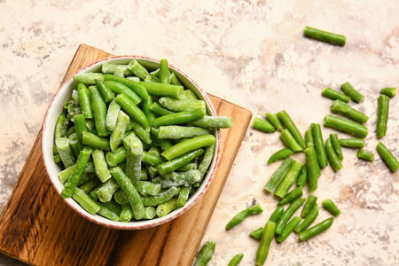 Bowl with frozen green beans on light backgroundの写真素材