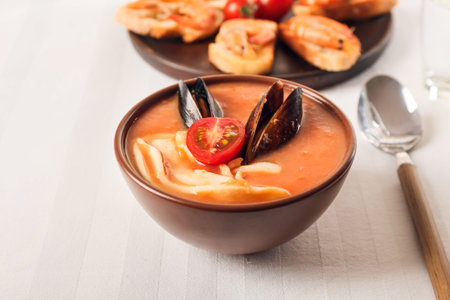 Bowl of tasty Cacciucco soup on tableの写真素材
