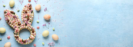 Beautiful cake for Easter celebration on blue background with space for text